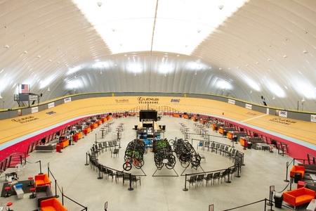 Interior photo of the Lexus Velodrome dome. Velodrome track around exterior of the dome with bicycles in center.